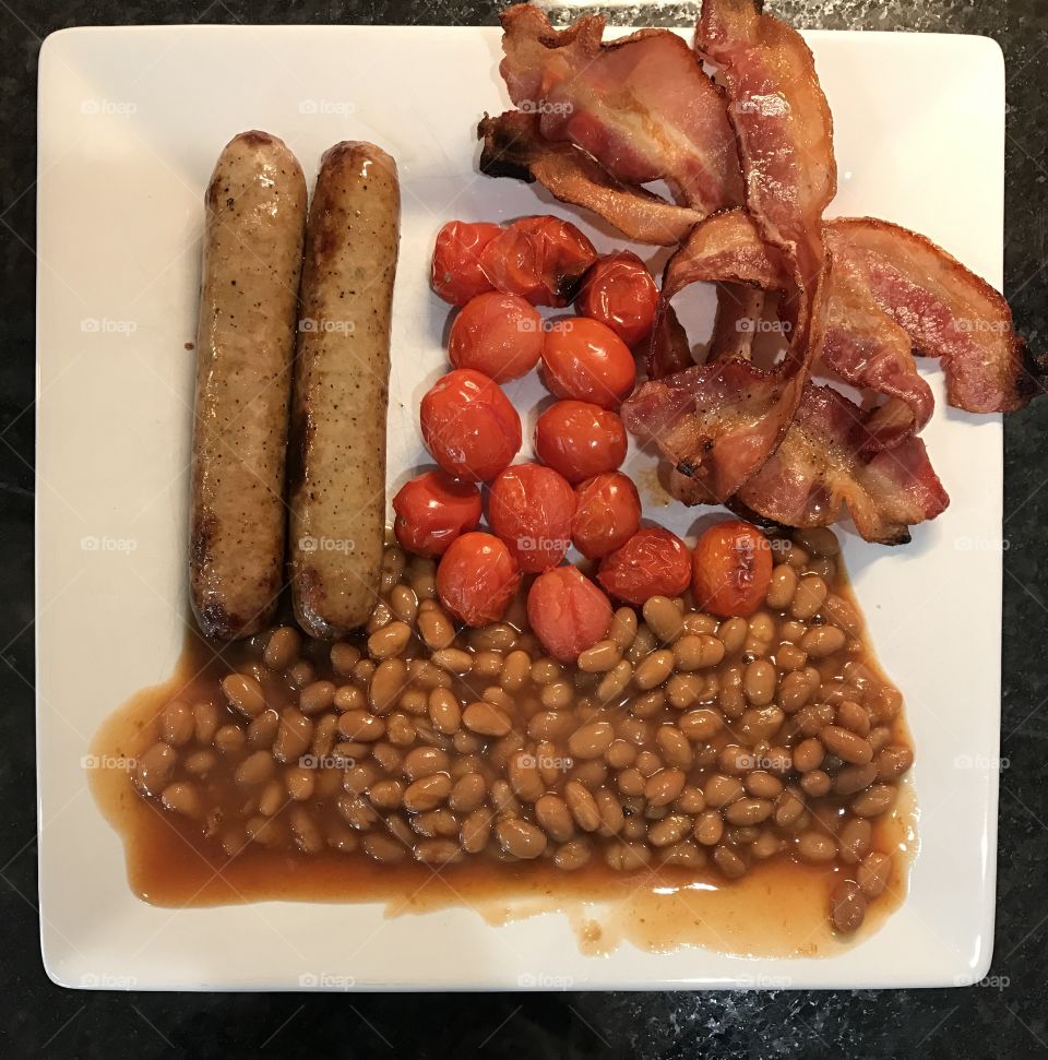 Breakfast bacon sausage beans tomatoes 