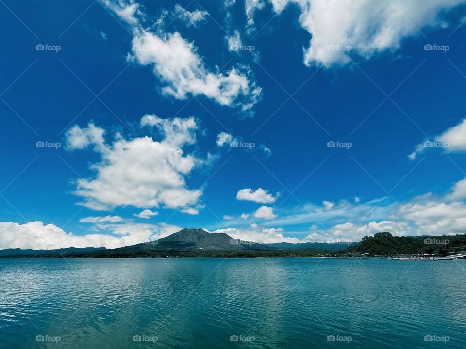 Portrait of a beautiful natural landscape with mountains, lakes and clear blue sky with white clouds