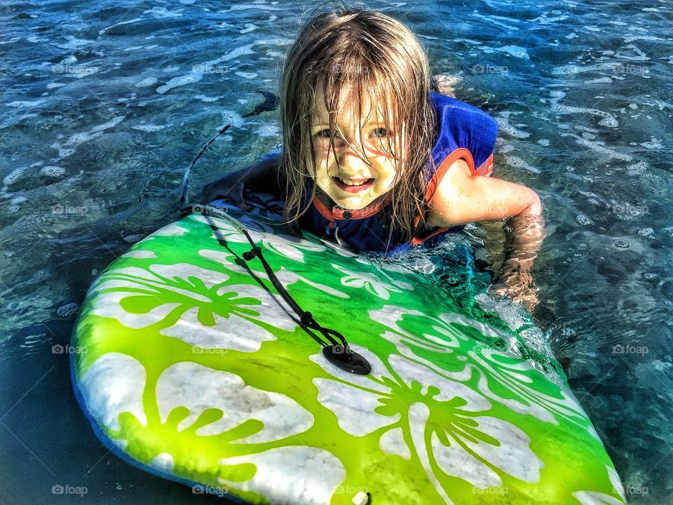 Girl surfing in sea