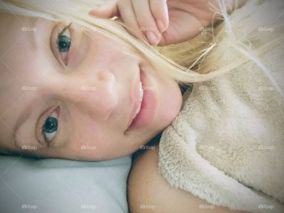 young beautiful blond woman waking up in the morning