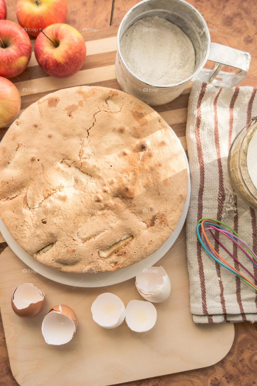 Making homemade puffed apple pie with eggs, sugar and flour.