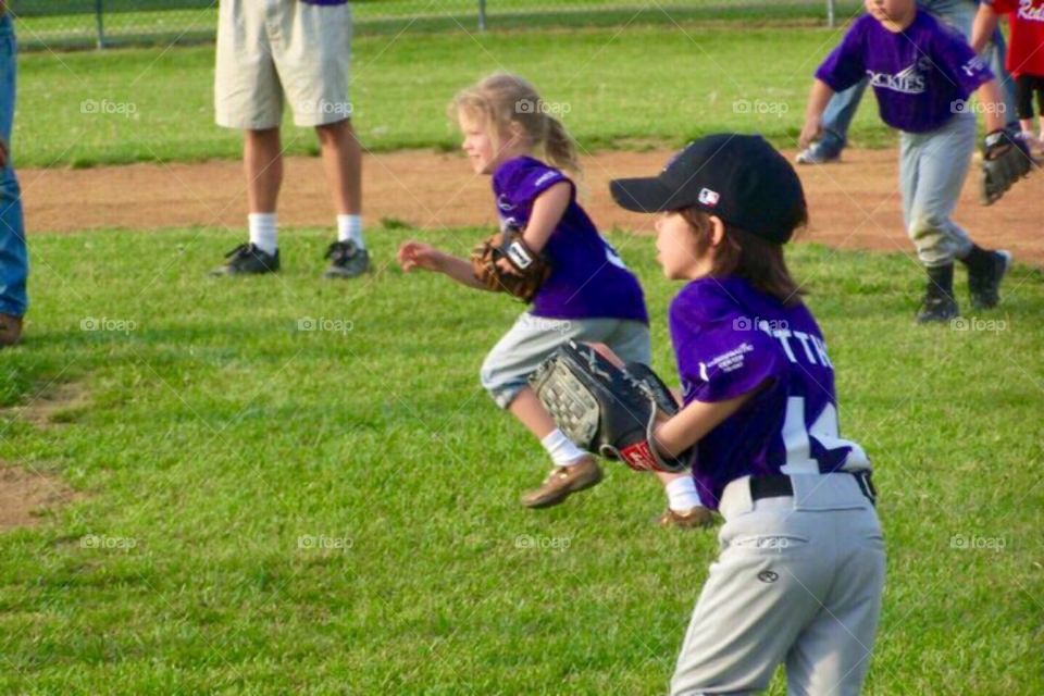 Small children playing baseball 