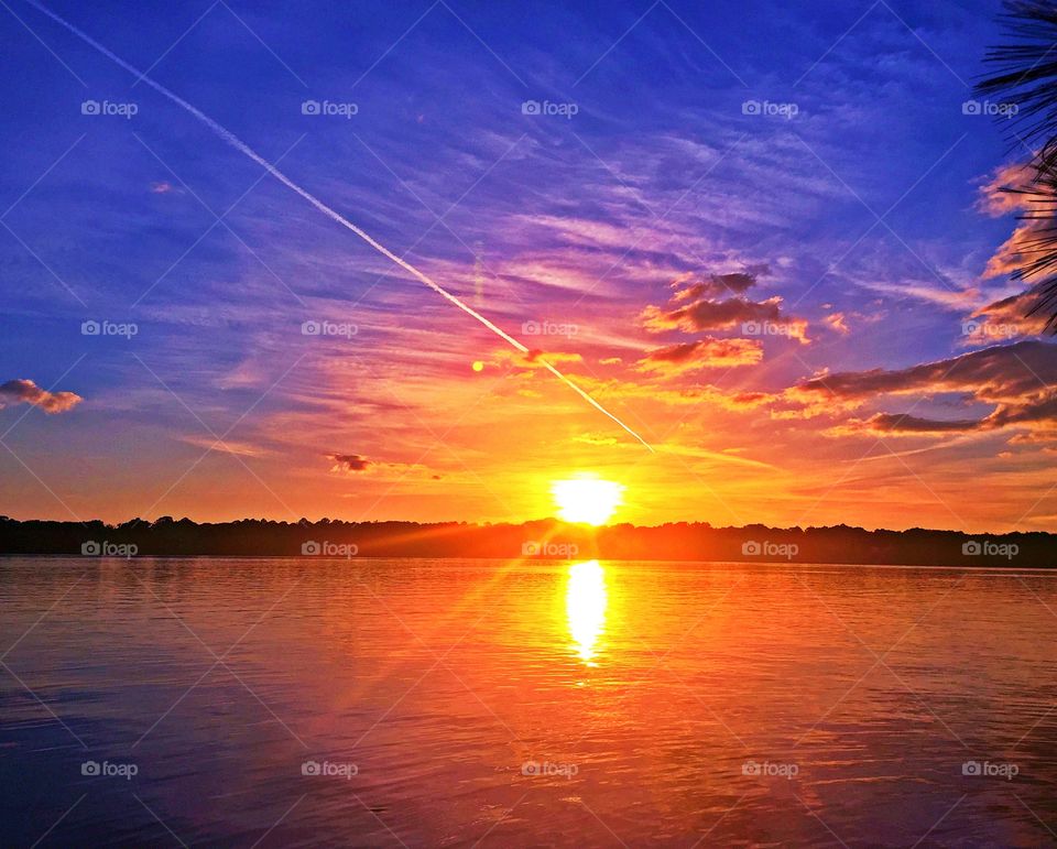 Seeing double - Gorgeous orange, yellow and blue hues backdrops leave spectators in awe as the sun makes its way toward the horizon.