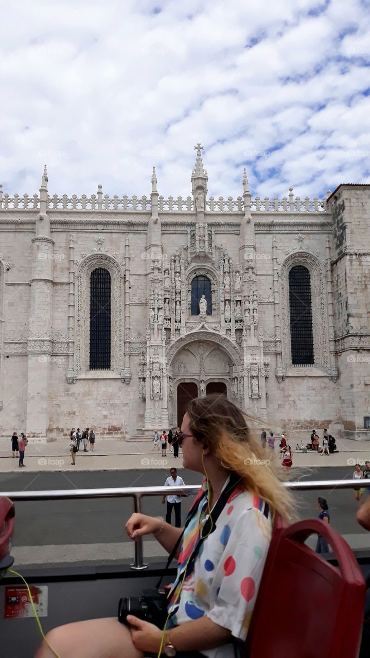 Tourist enjoying the monuments and historic buildings in a city tour through the city of Lisbon, Portugal.