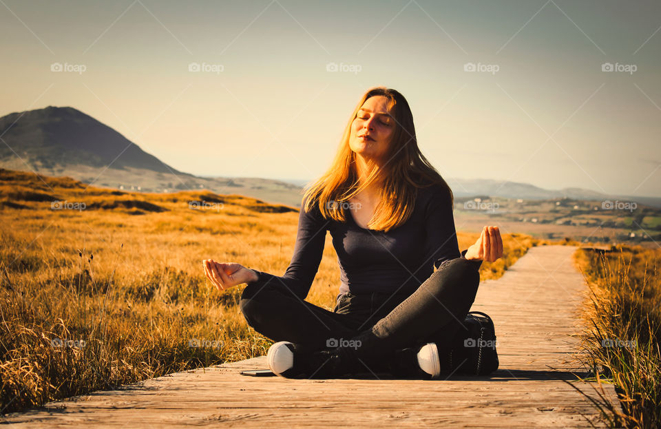 Viki meditating at Golden hour in the mountains of Connemara national park