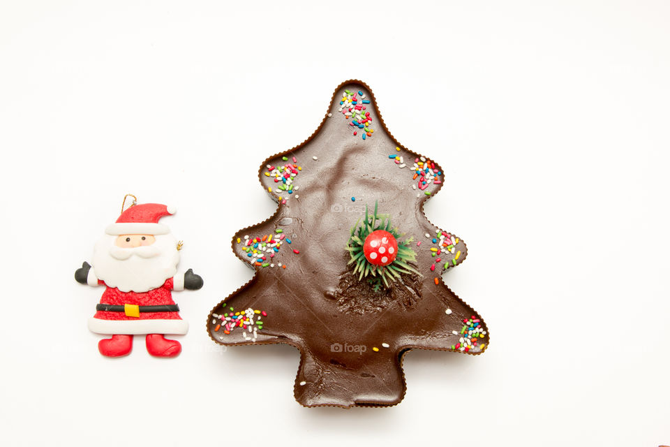 Composition Of Christmas Tree Chocolate Muffin Cupcake And Santa Claus, Isolated On White Background
