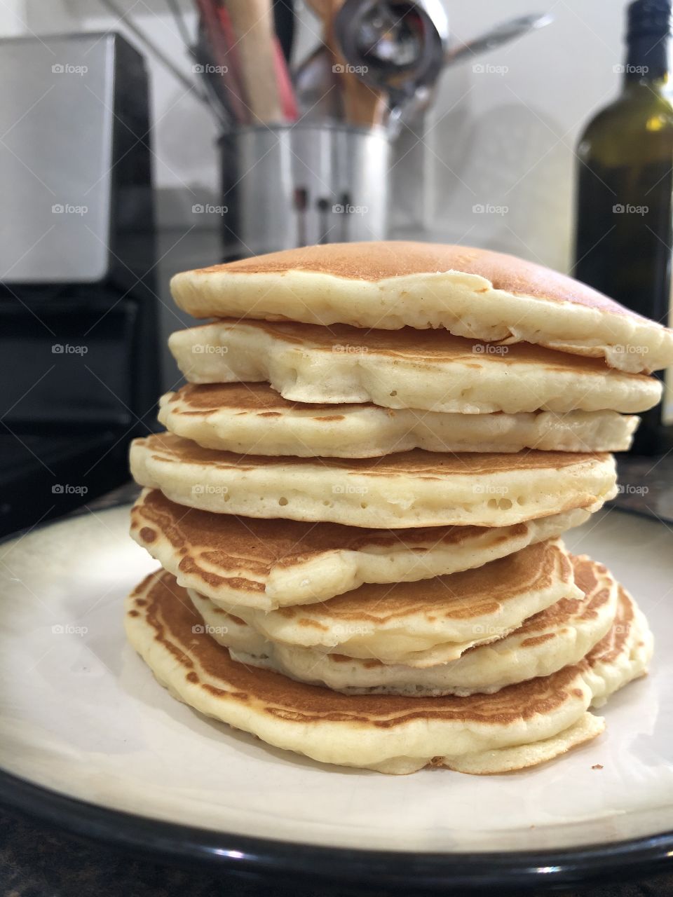 Closeup of stack of pancakes on kitchen counter 