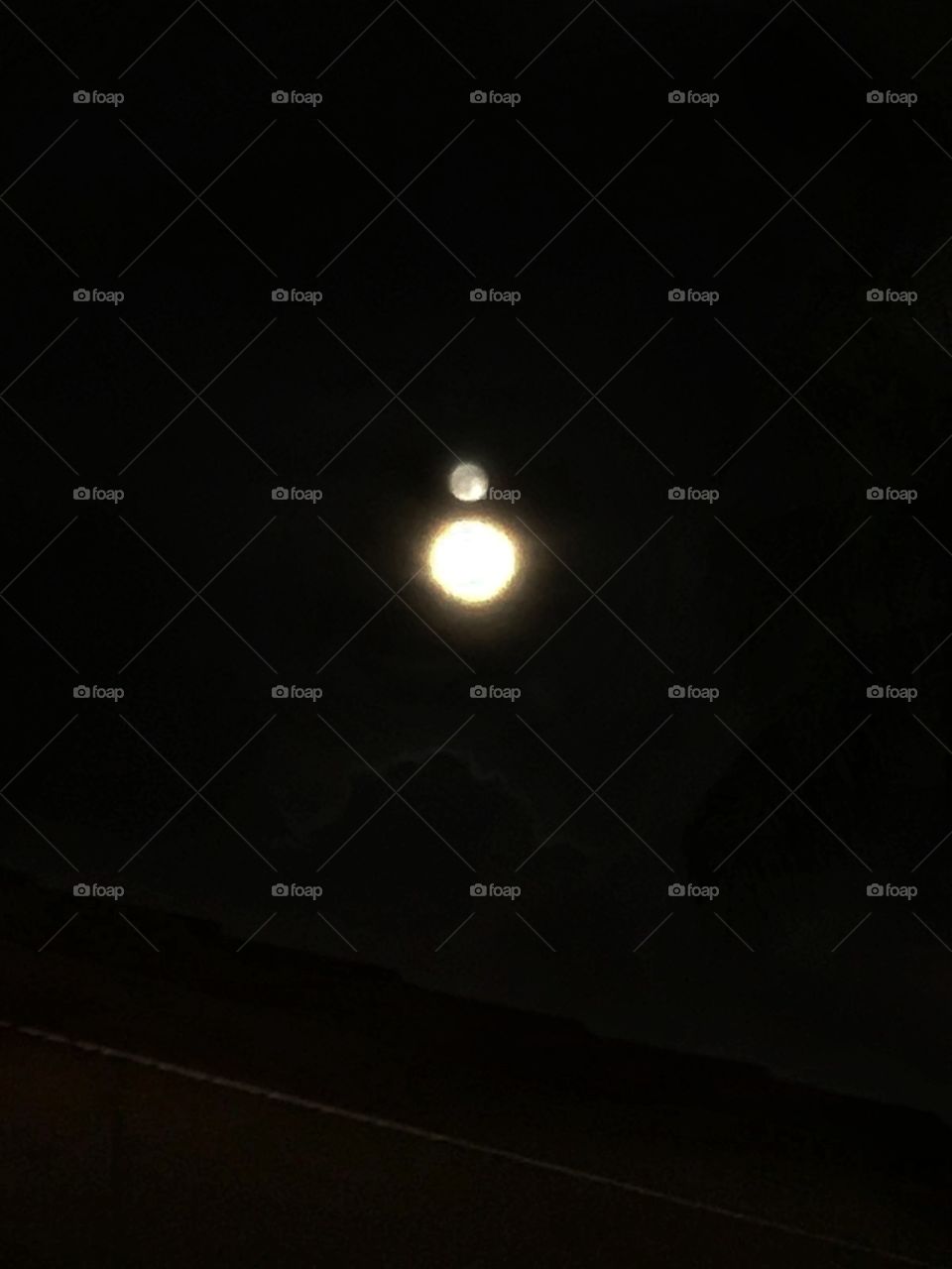 Bright moon and its reflection above it