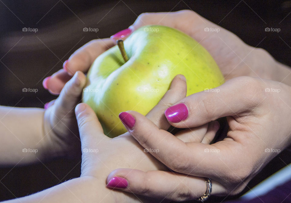 Mother with a small child holding an apple