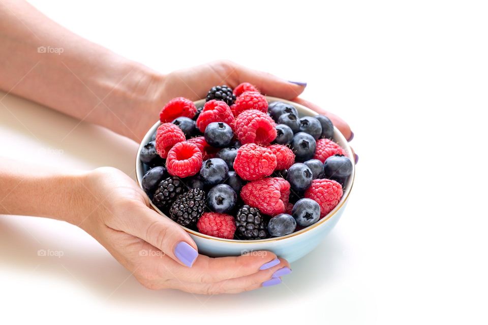 Juicy fresh berries in a bowl as healthy summer treat