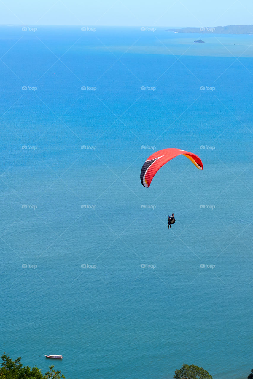 paragliding over the blue sea