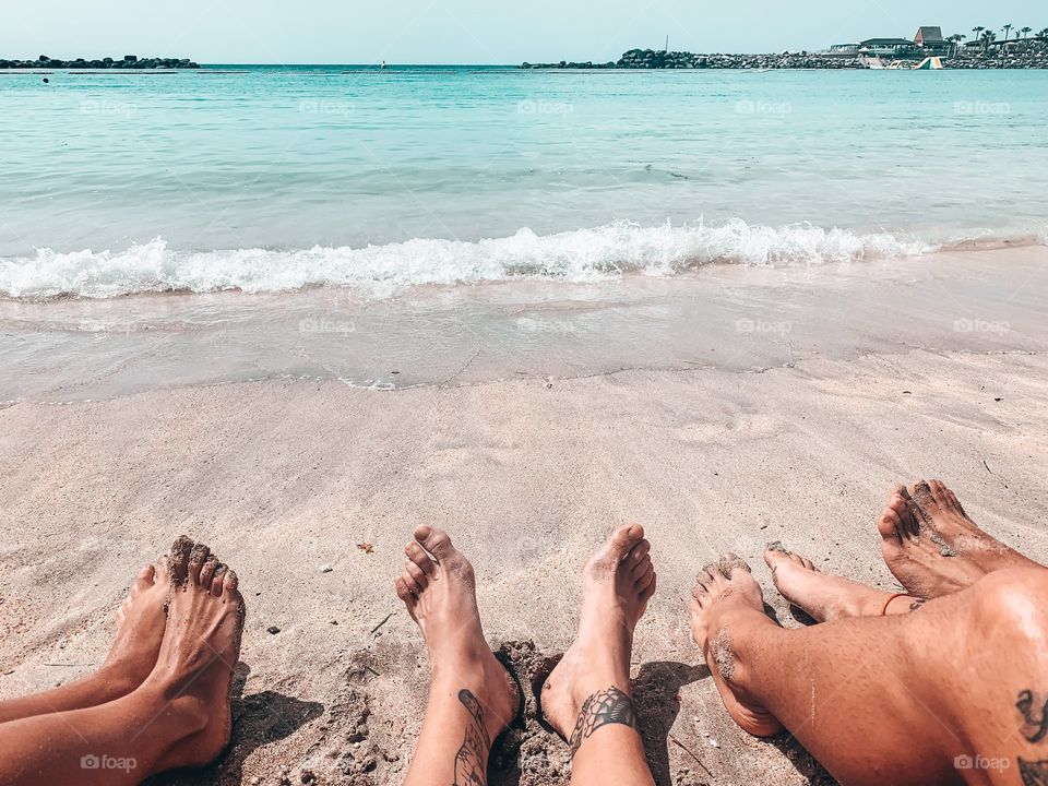 Friends in seashore of a beach during day 