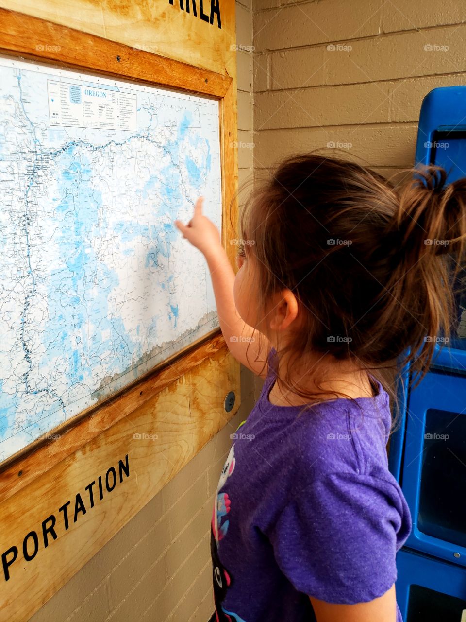 young girl looking at a map