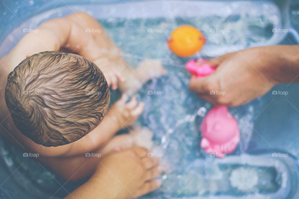 Baby playing in the water on a hot summer day in Brazil