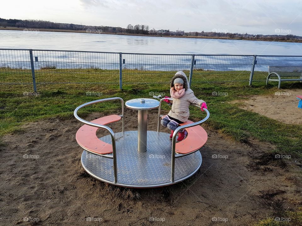 Small girl playing on a playground