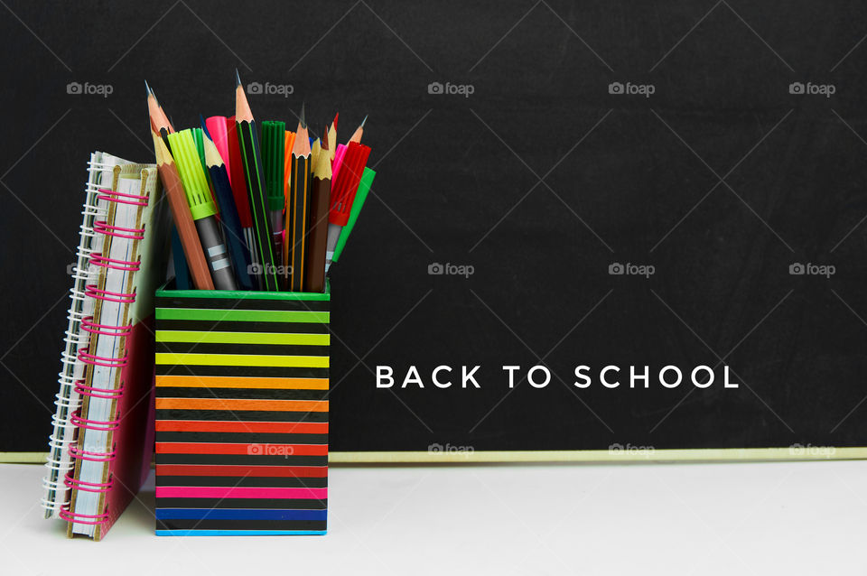 Back to school concept with school supplies on black background 