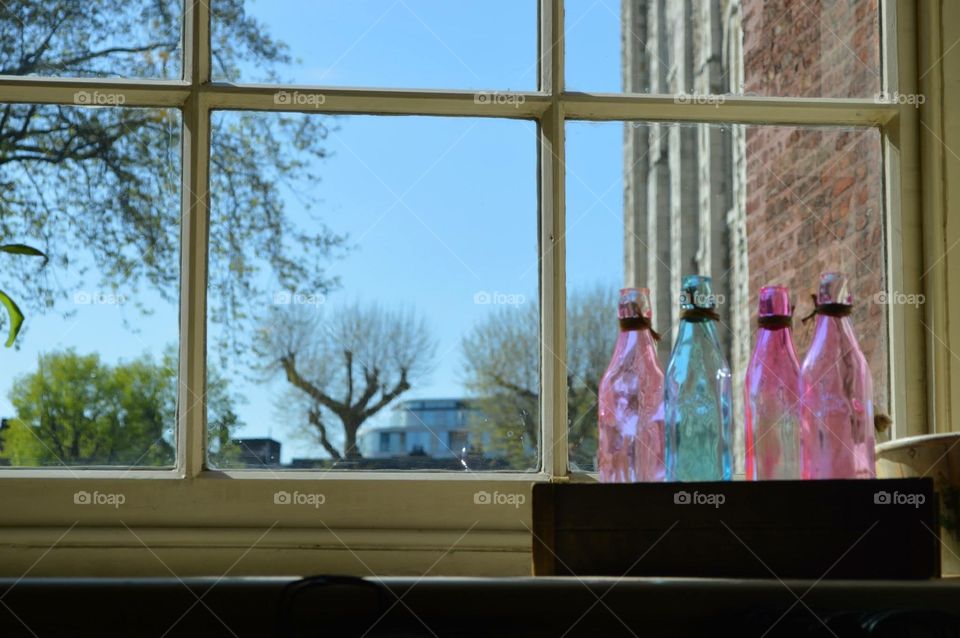 Cotton Candy Colored Bottle Sit in Windowsill