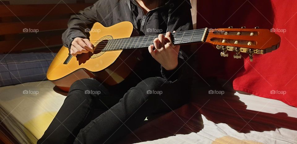 A moment in our personal space, playing the guitar, a very beautiful musical instrument and a spectacular sound