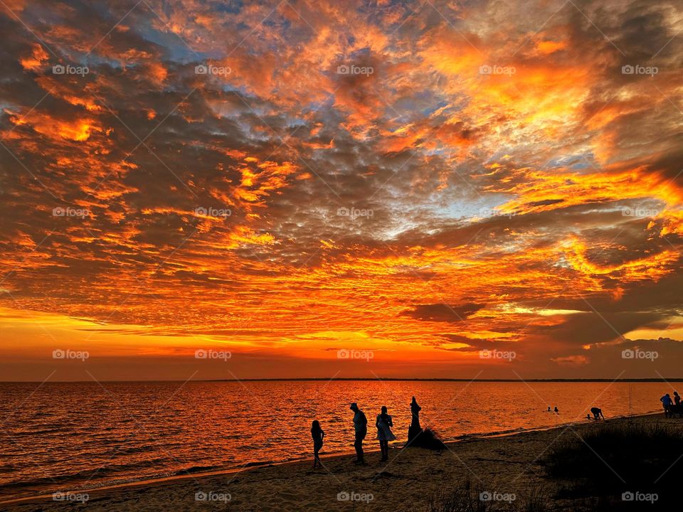A family enjoys the January sunset on the Gulf of Mexico - If you are in a beautiful place where you can enjoy sunrise and sunset, then you are living like a king or queen
