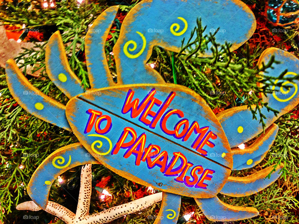 Welcome to paradise crab sign.