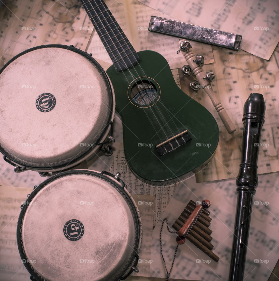 Flat lay of musical instruments on top of sheet music