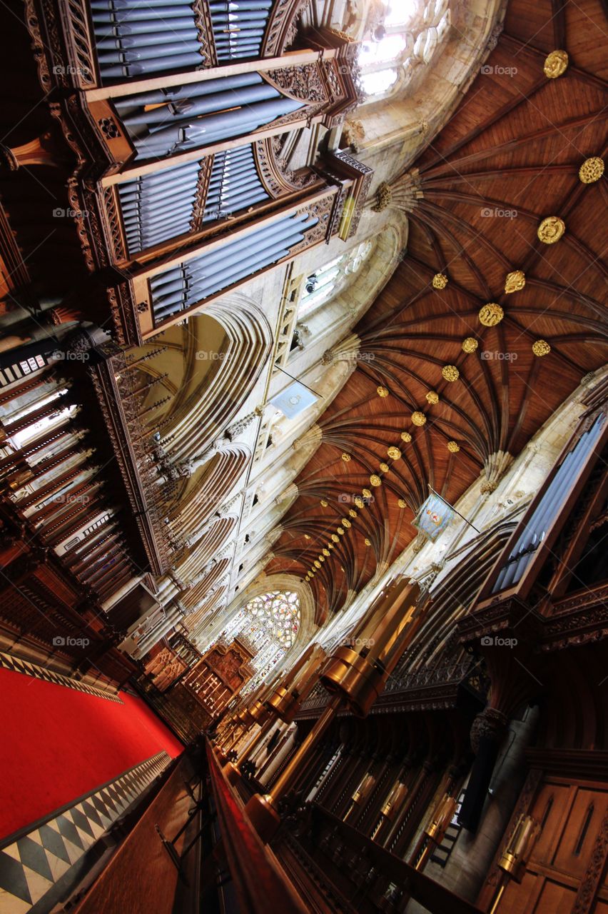 The interior of Selby Abbey in Yorkshire at a dramatic angle. Ornate carvings and red carpet in a beautiful Cathedral.