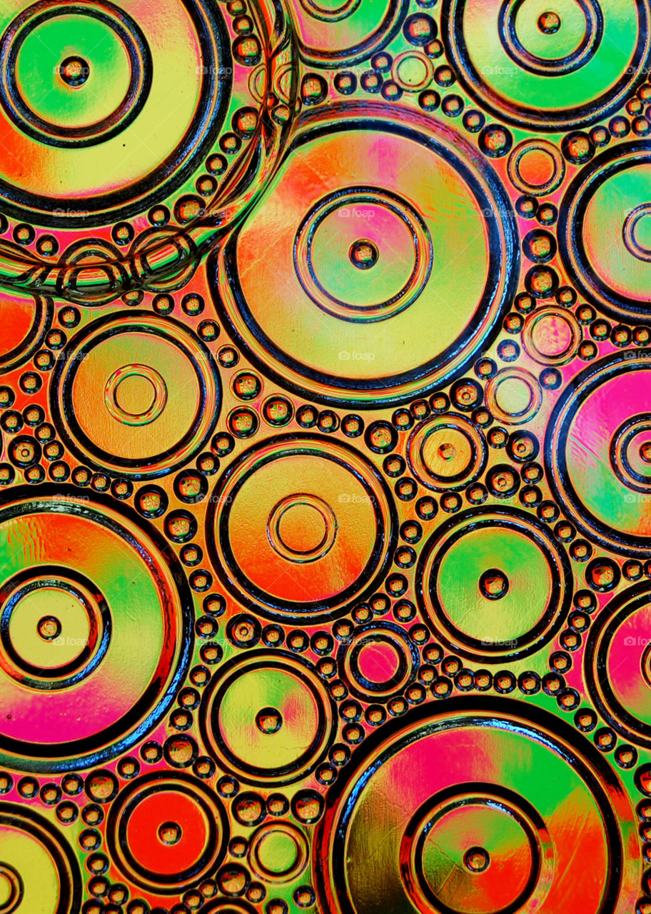 Clash of colors.  Fluorescent colors reflected into a clear candy dish.