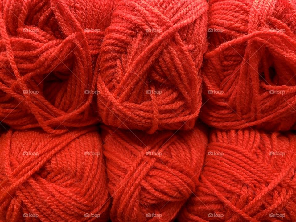 Set of red wool yarn balls close up, knitting material, hand made creations 