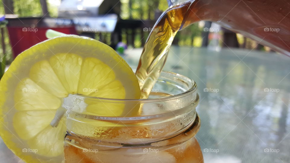 Close-up of pouring ice tea