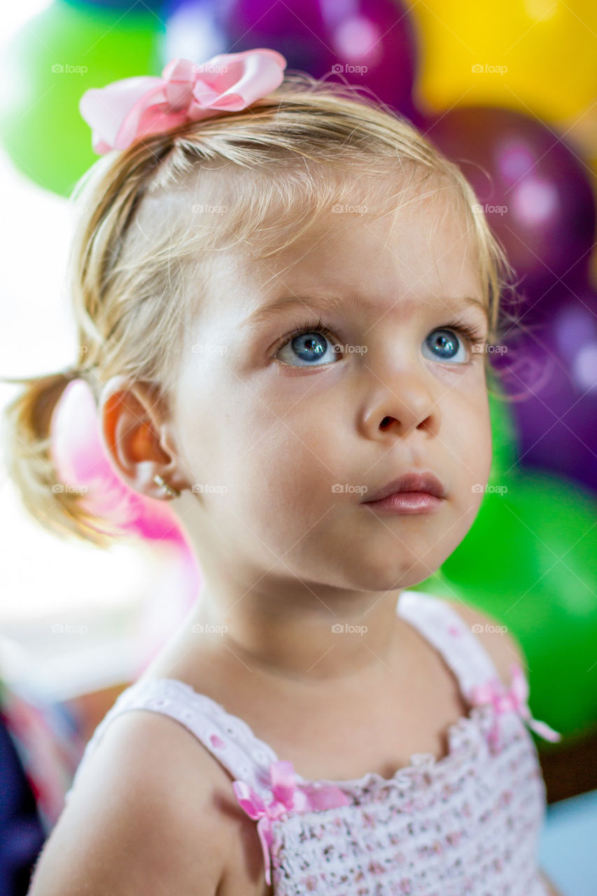 Baby girl watching a parade in a party