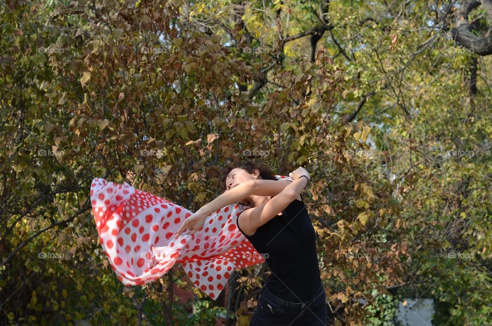 Beautiful Young Woman Dancing with Scarf Outside in Nature