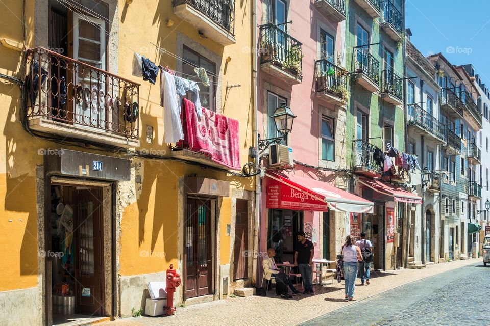 Old colorful buildings and people in Alfama, old town, Lisbon, Portugal