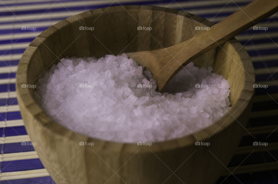 salt in a bamboo bowl with spoon