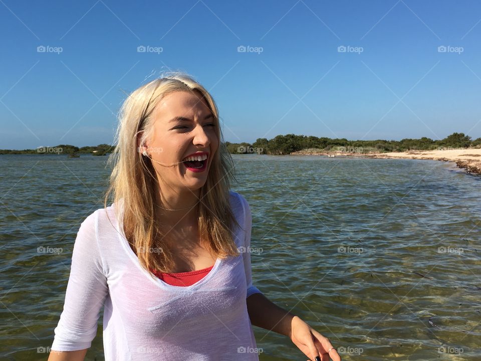 Happy woman standing near sea