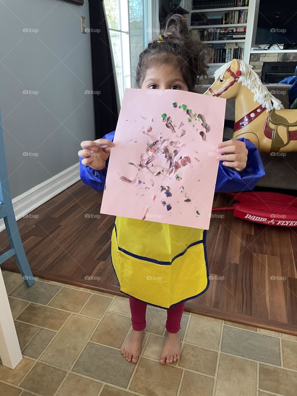 Child shows off finger painting, child art work, toddler is proud of art work, making crafts with toddlers, winter activities for children at home, fun with paint 