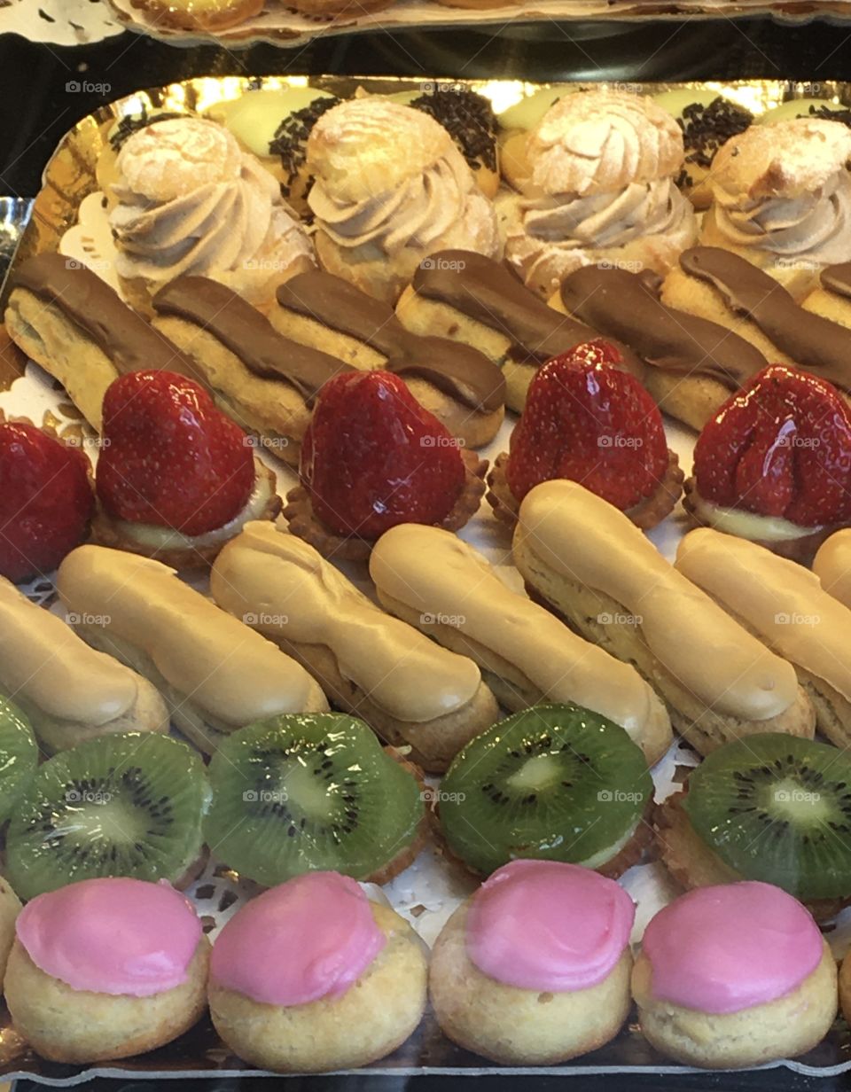 Colored cookies on a tray, with pinky ones