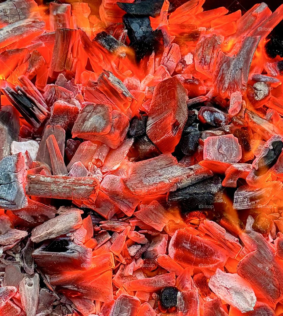 Close-up of burning red charcoal