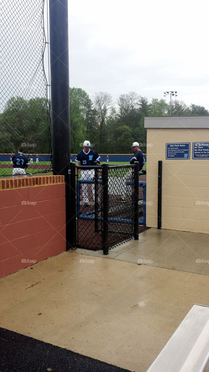 rainy day baseball. players try to stay dry