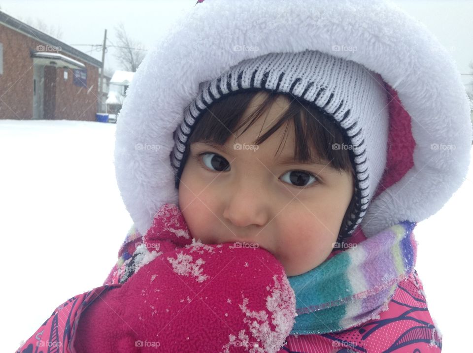 Close-up of a little boy with knitted cap during winter