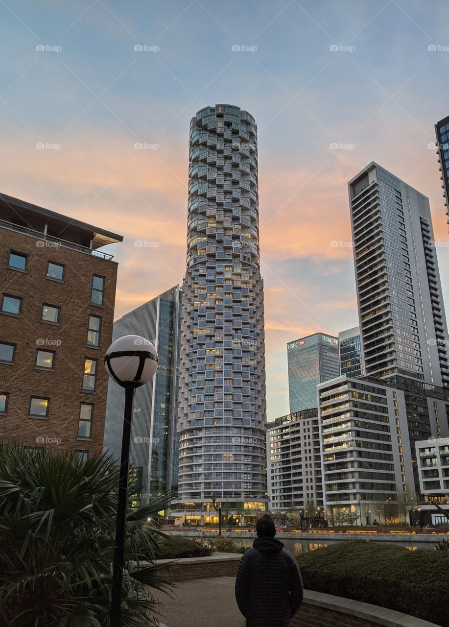 Admiring the sunset. Beautiful sunset creating interesting patterns on buildings by the water.