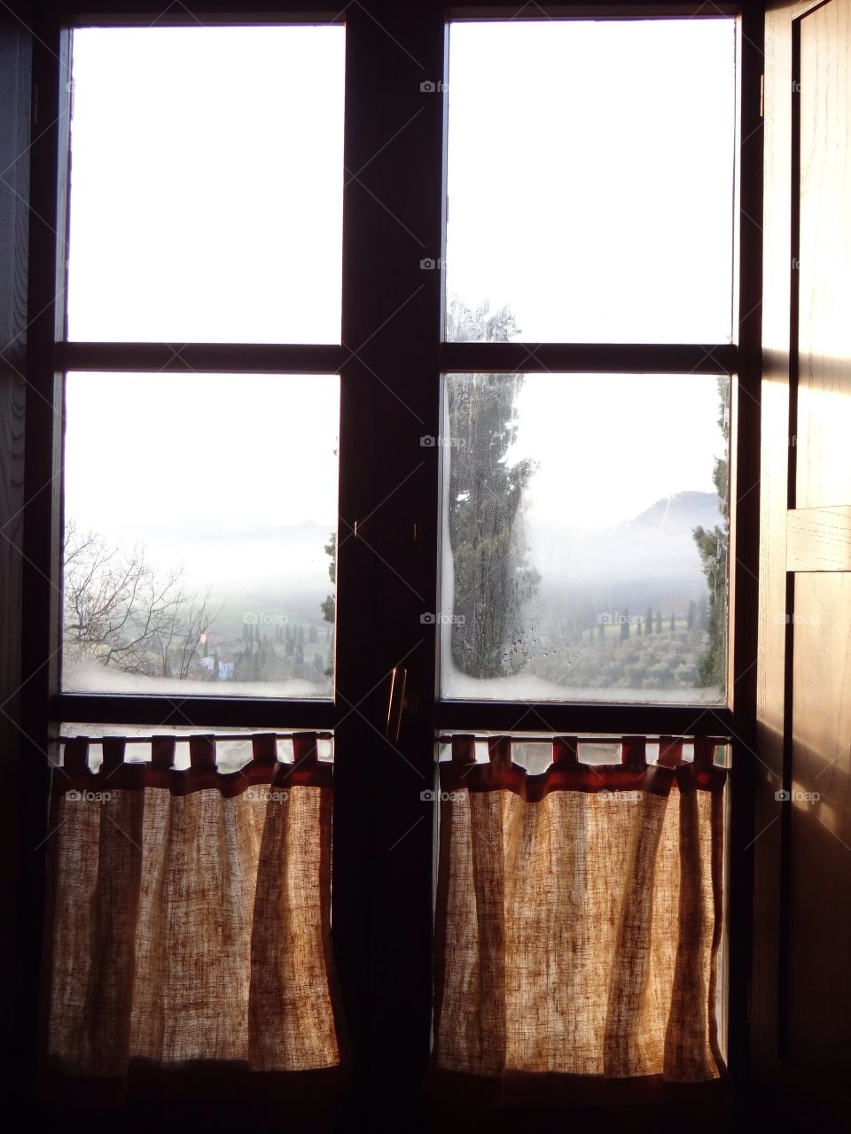Tuscan landscape seen from an old window