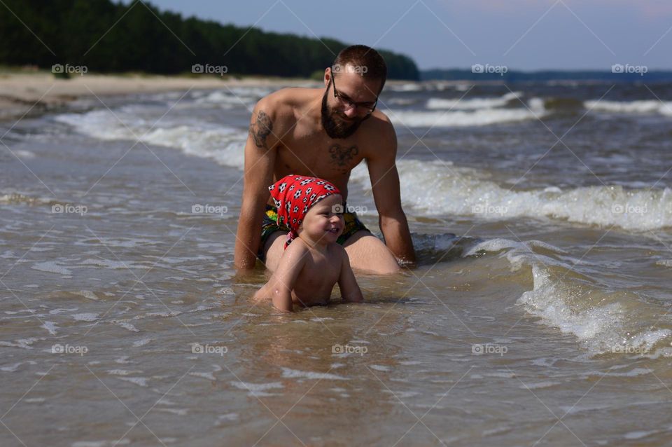 father and son engoying hot summer day on the beach