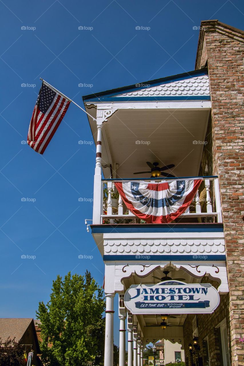 American flag flying high for July fourth celebrations in Jamestown California at the Jamestown hotel 