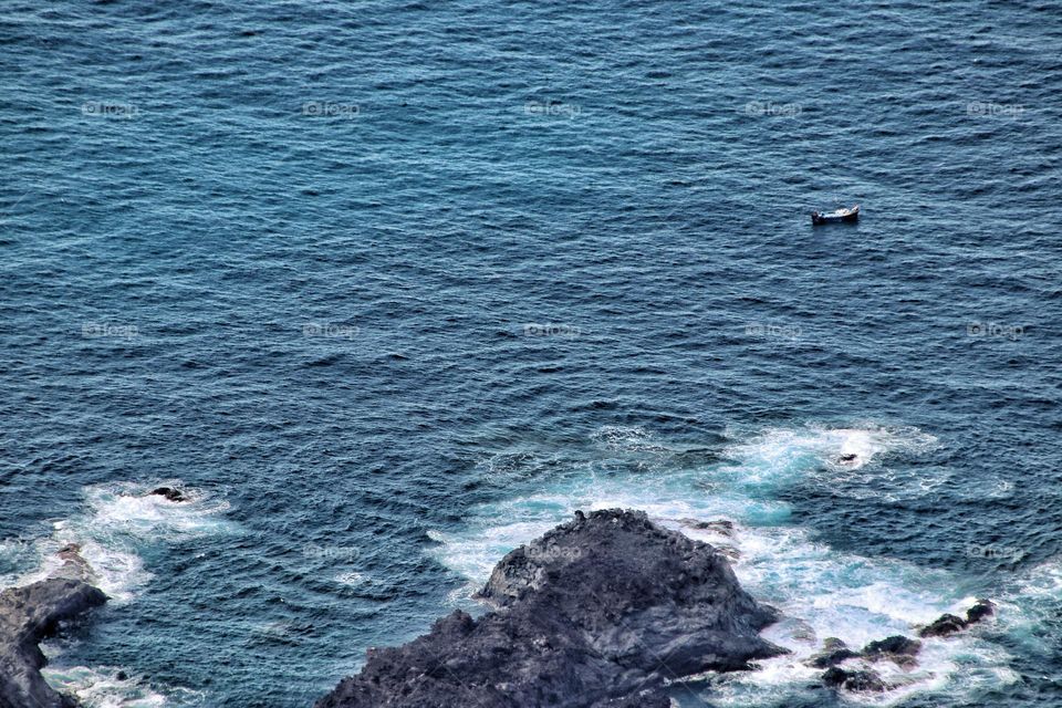 Aerial view of the rough blue Atlantic Ocean with one boat