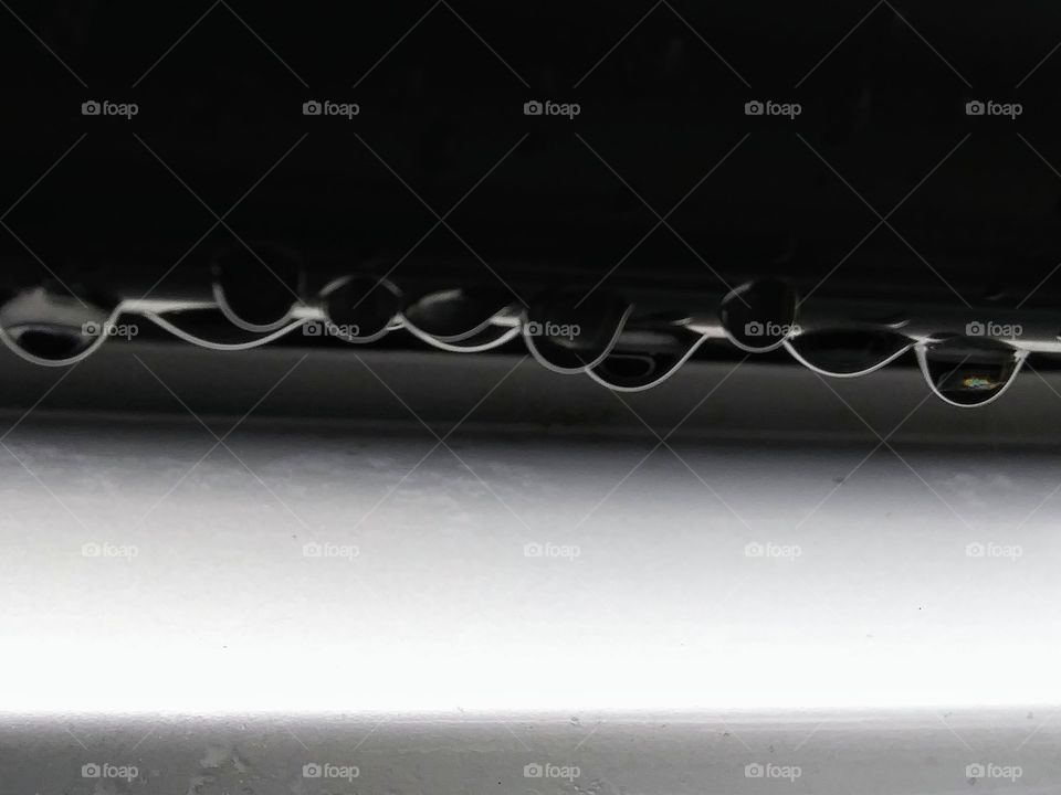 water droplets hanging from a surface