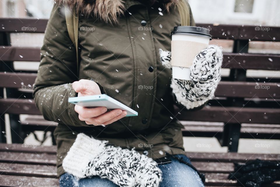Girl using mobile in winter