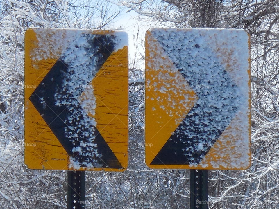 Road signs arrows snowy
