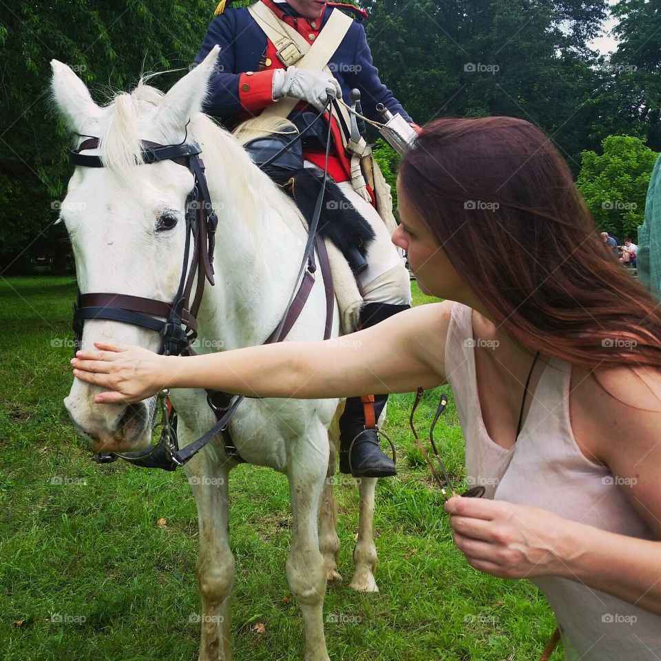 A beautiful woman meets a beautiful horse