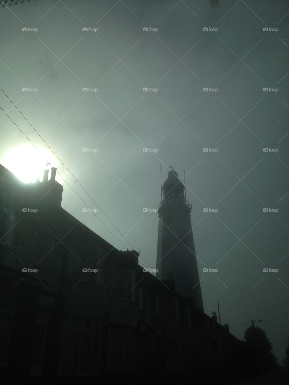 Evening by the Lighthouse. Walking through a seaside town at evening time