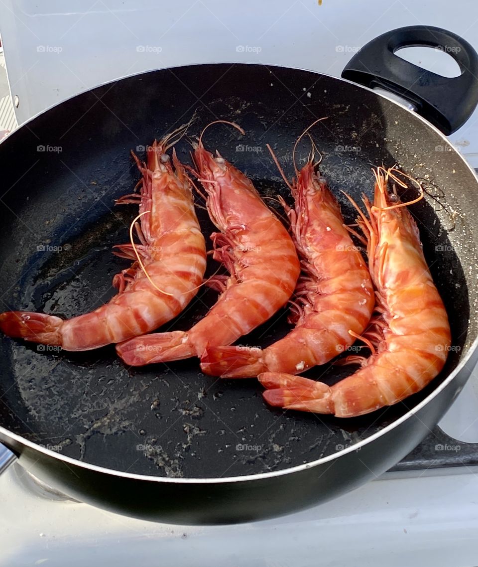 Scampi or king prawn being cooked